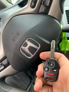 Automotive locksmith coding a new Honda key on site