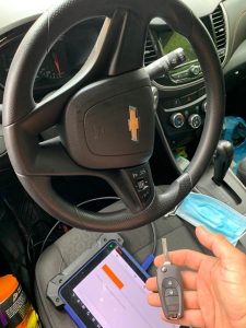 Automotive locksmith coding a Chevrolet Spark keys with a chip