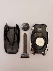 The key fob on the inside - battery , chip and emergency key