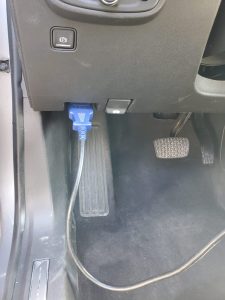 Automotive locksmith is connecting the coding machine to the car's obd to program new keys