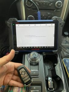 An automotive locksmith coding new Ford key fobs on-site