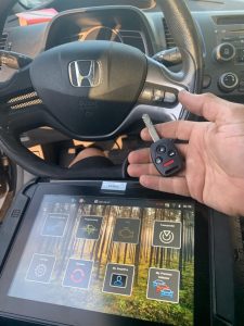 An automotive locksmith coding a new Honda Civic key