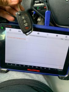 In the picture: automotive locksmith connected a coding machine to program the new key