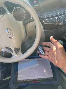 Automotive locksmith coding an Infiniti M56 key fob