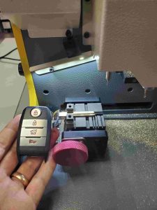 New Kia key fob on a computer operated cutting machine