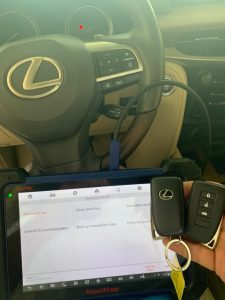 Automotive locksmith coding a new Lexus key fobs on-site with a special coding machine