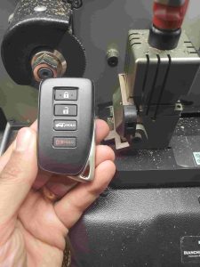 Cutting machine used by an automotive locksmith for Lexus keys