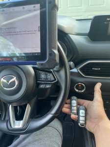 4 buttons Mazda key fob (WAZX1T768SKE11A03) coded on site by an automotive locksmith