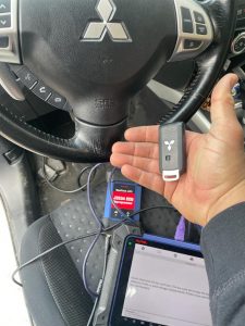 Automotive locksmith coding a new Mitsubishi key fob on-site