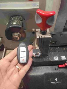 Nissan Pathfinder key fob on a cutting machine