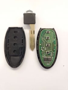 An inside look of key fob, emergency key and chip - Nissan