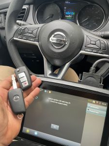 Automotive locksmith coding a new Nissan key on-site