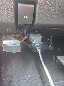 Automotive locksmith is connecting the coding machine to the car's obd to program new keysAutomotive locksmith is connecting the coding machine to the car's obd to program new keys
